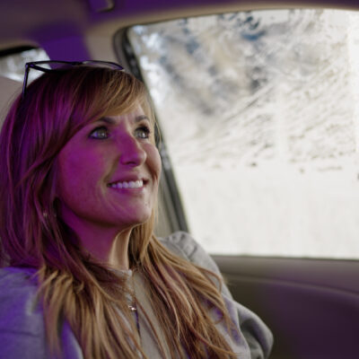 A Tidal Wave Auto Spa customer enjoys her car wash in Omaha, NE